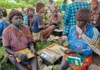 women counting money in a women's group in Ethiopia